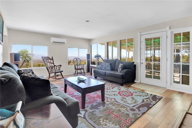 living room with light hardwood / wood-style floors and a wall mounted AC