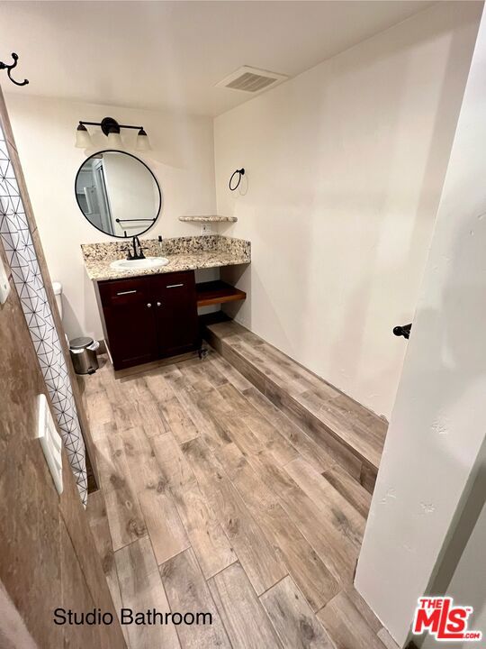 bathroom featuring vanity and hardwood / wood-style floors