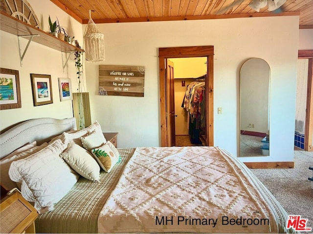 carpeted bedroom featuring a spacious closet and wooden ceiling