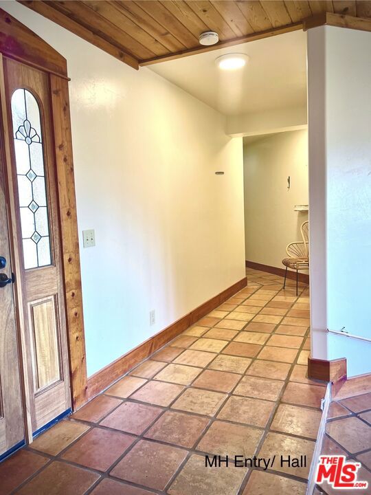 entryway with vaulted ceiling and wood ceiling