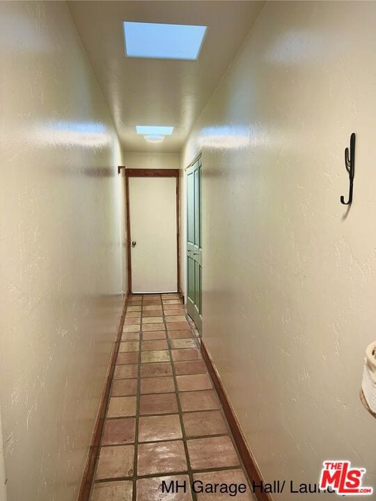 corridor featuring tile patterned flooring