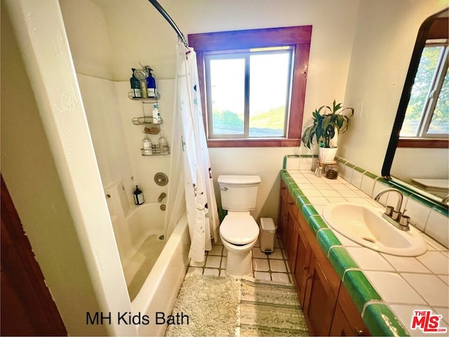 full bathroom featuring vanity, shower / bathtub combination with curtain, toilet, and tile patterned floors