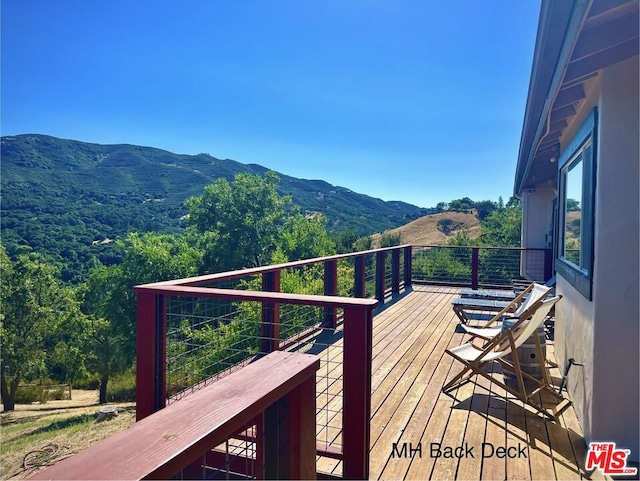 wooden deck featuring a mountain view