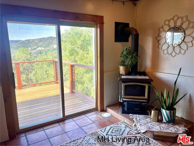 doorway to outside featuring a mountain view and a wood stove