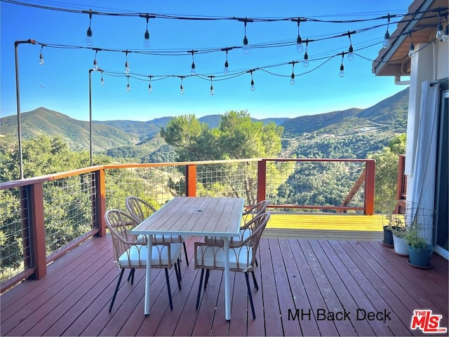 wooden deck with a mountain view