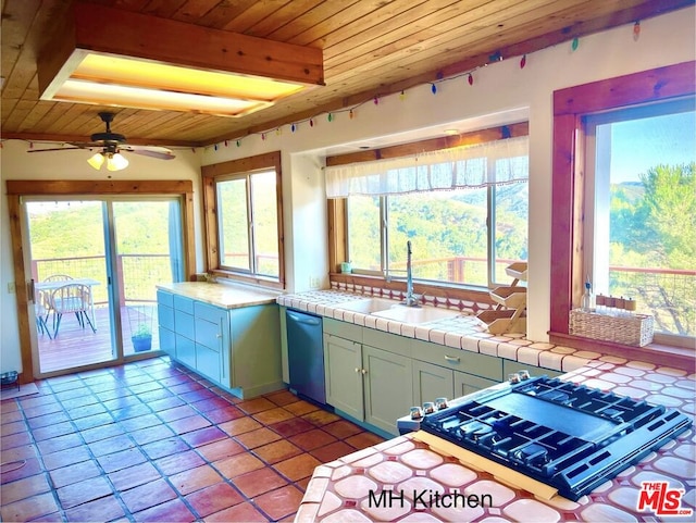 kitchen with wooden ceiling, a wealth of natural light, stainless steel dishwasher, and tile counters