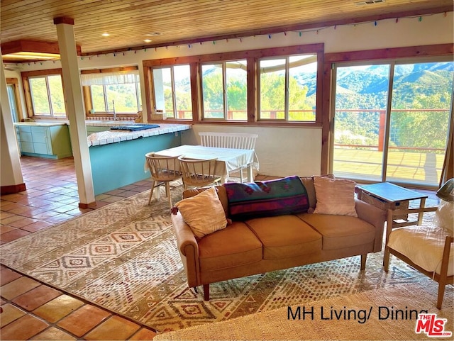 sunroom / solarium featuring sink, wood ceiling, and plenty of natural light