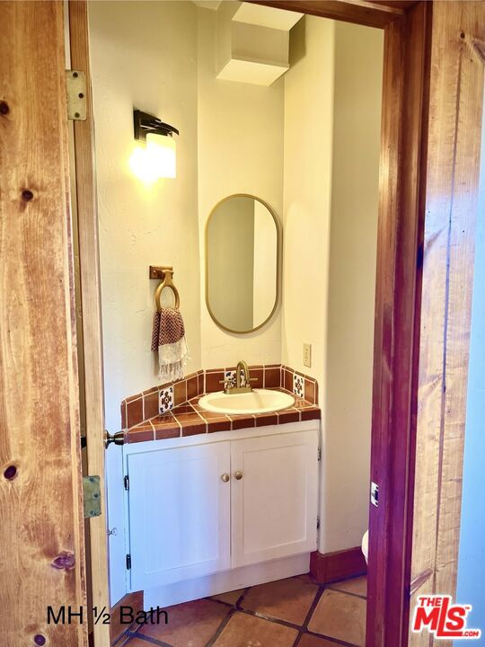 bathroom with vanity and tile patterned flooring