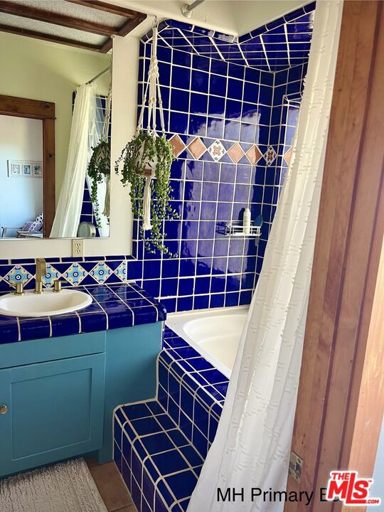 bathroom featuring vanity, shower with separate bathtub, and tile patterned flooring