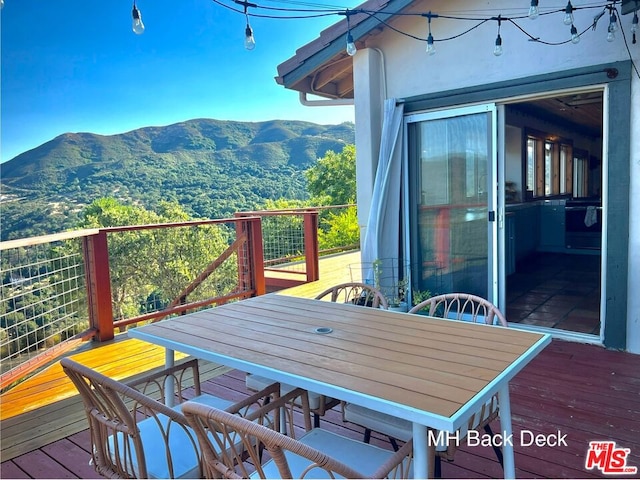 wooden deck featuring a mountain view