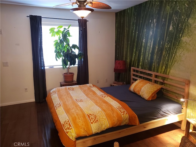 bedroom featuring ceiling fan and dark wood-type flooring