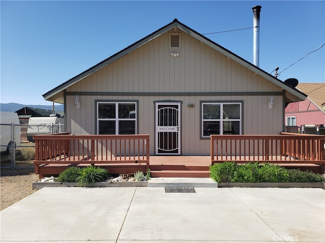 view of front of house featuring a patio and a wooden deck