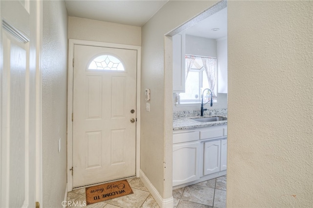 doorway featuring a wealth of natural light and sink