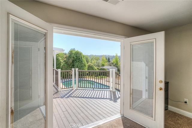 doorway to outside with carpet floors