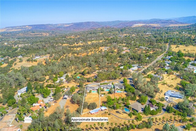 birds eye view of property with a mountain view