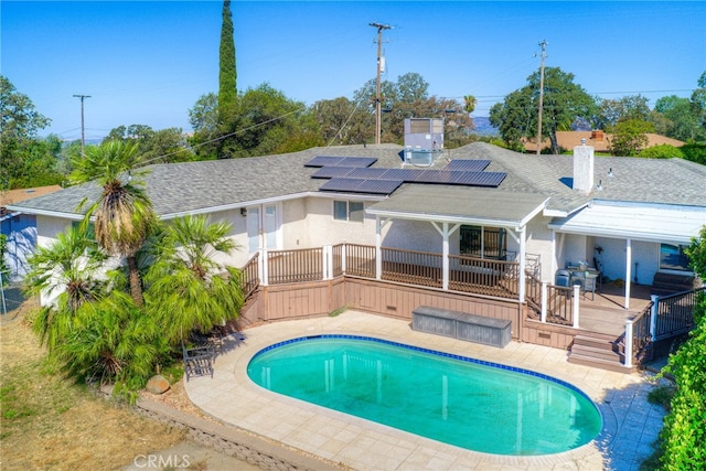 view of swimming pool featuring a patio, area for grilling, and a wooden deck