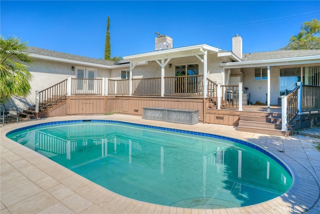 view of pool featuring a patio area and a deck