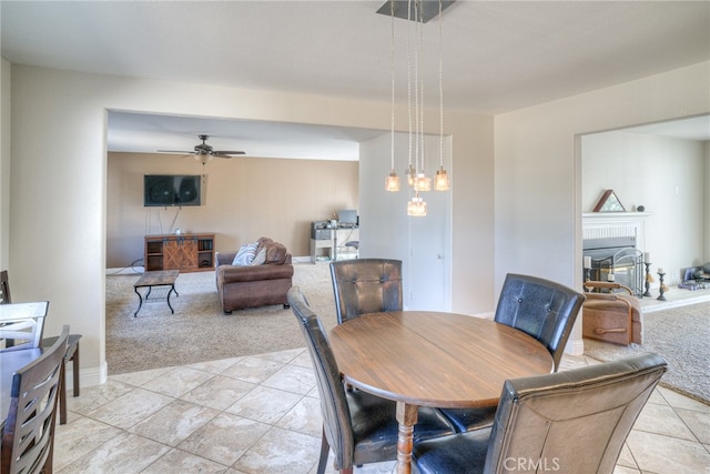 carpeted dining space featuring ceiling fan