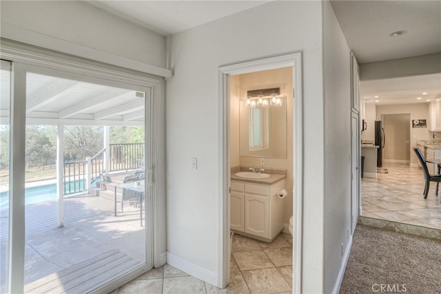 bathroom with a shower with curtain, vanity, toilet, and tile patterned floors