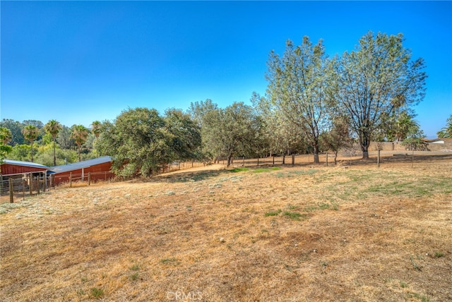 view of yard with a rural view