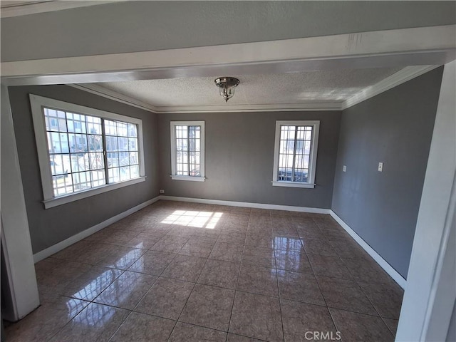 unfurnished room with a textured ceiling, ornamental molding, and a healthy amount of sunlight