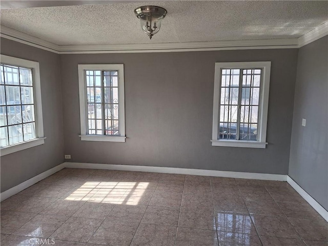 spare room with ornamental molding, a wealth of natural light, and a textured ceiling