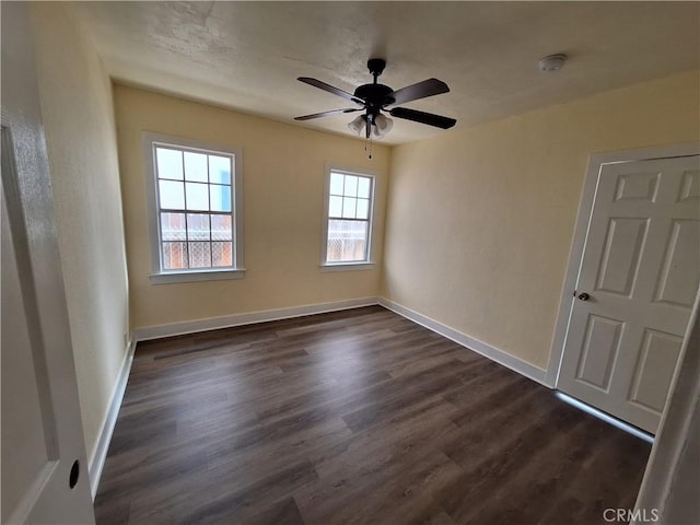 interior space with dark hardwood / wood-style floors and ceiling fan