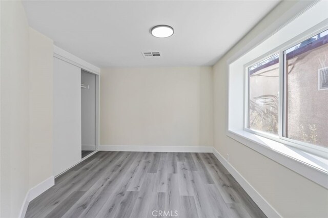 spare room featuring light hardwood / wood-style floors