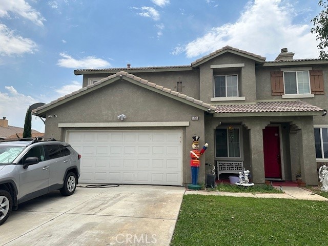 front of property with a front lawn and a garage