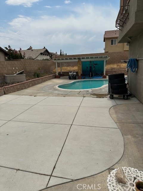 view of swimming pool with a patio