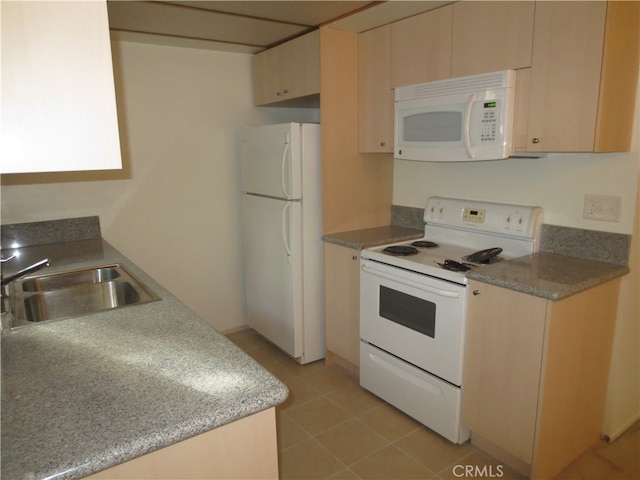 kitchen featuring white appliances, light brown cabinets, light tile patterned flooring, and sink