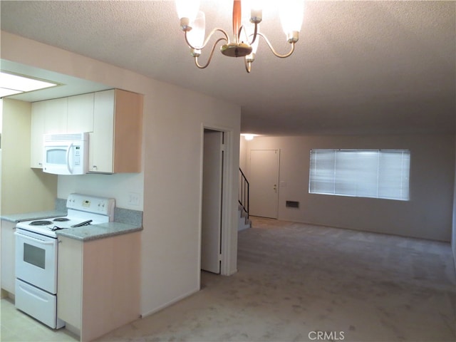 kitchen featuring white cabinets, white appliances, a textured ceiling, light carpet, and a notable chandelier