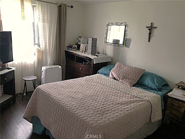 bedroom featuring dark hardwood / wood-style flooring