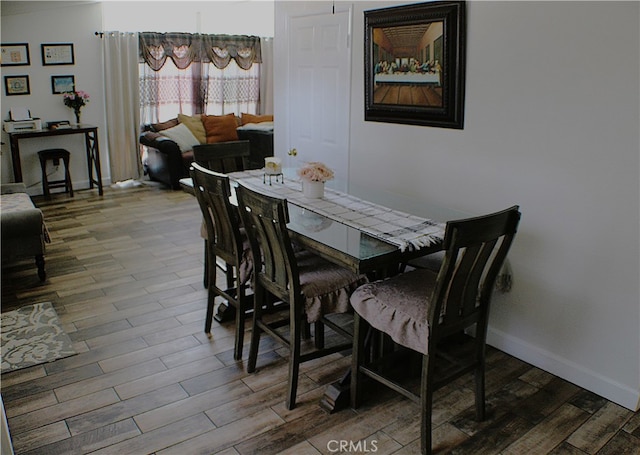 dining space with hardwood / wood-style floors