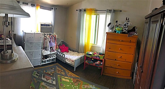 bedroom with cooling unit and hardwood / wood-style floors