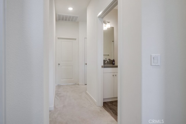 hallway with light colored carpet