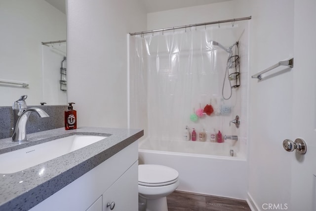 full bathroom with vanity, hardwood / wood-style floors, toilet, and shower / tub combo