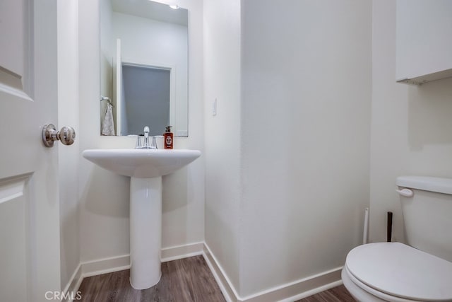 bathroom featuring toilet and hardwood / wood-style flooring