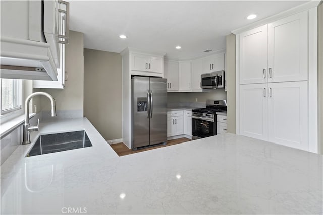 kitchen featuring white cabinetry, stainless steel appliances, and sink