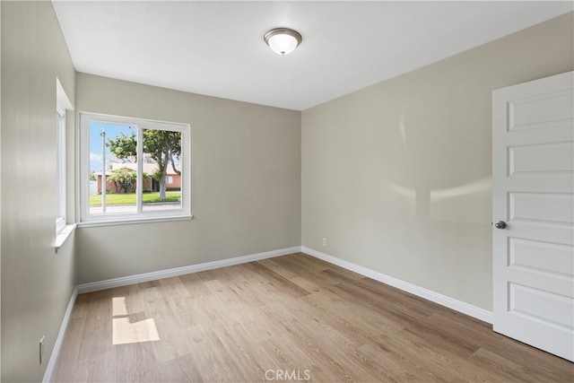 spare room with light wood-type flooring