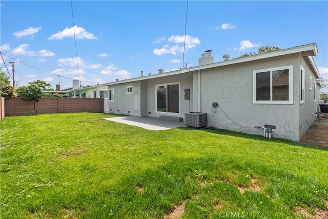 rear view of property featuring central AC, a yard, and a patio area