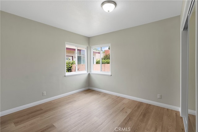 empty room with light hardwood / wood-style flooring