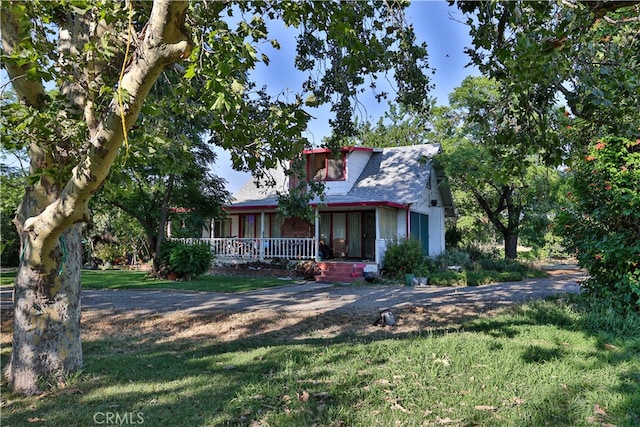 view of front of property with a front yard and a porch