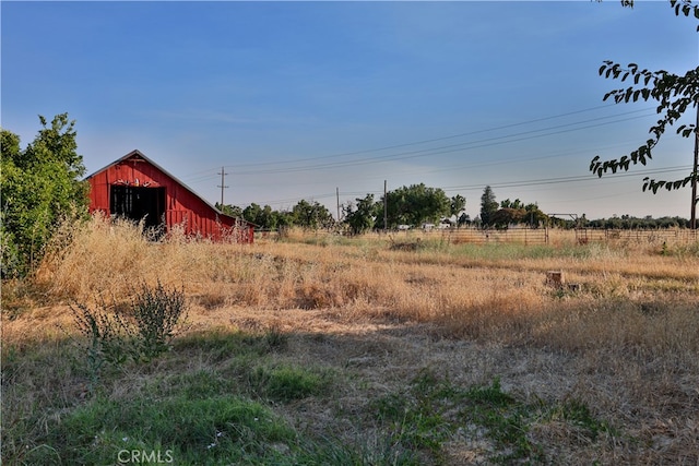 view of yard featuring an outbuilding and a rural view