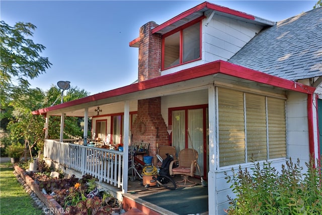 back of property with covered porch