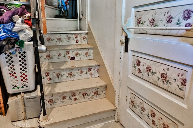 staircase featuring tile patterned floors