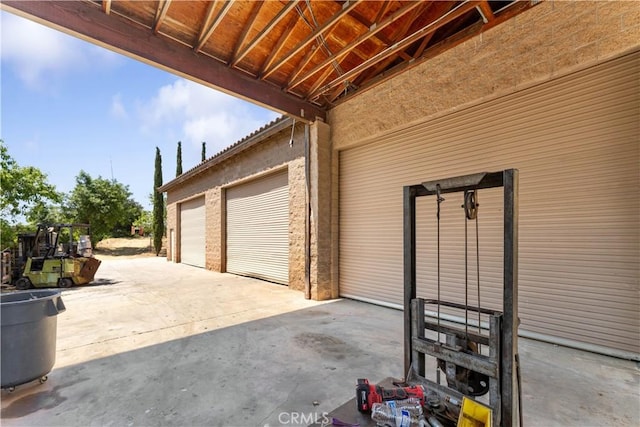garage featuring concrete driveway