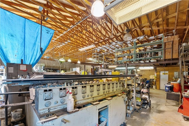 miscellaneous room featuring concrete floors and a workshop area