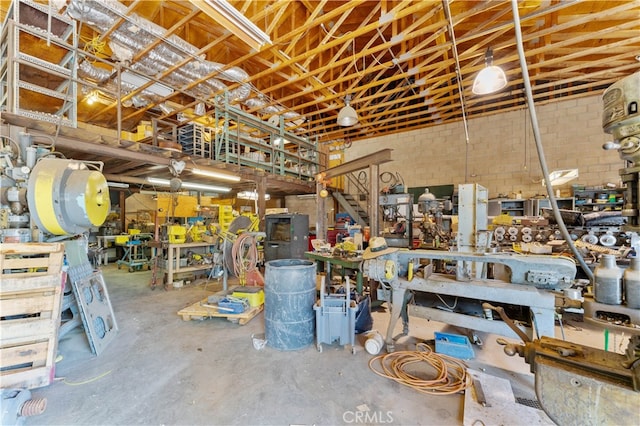 misc room featuring a workshop area and concrete floors