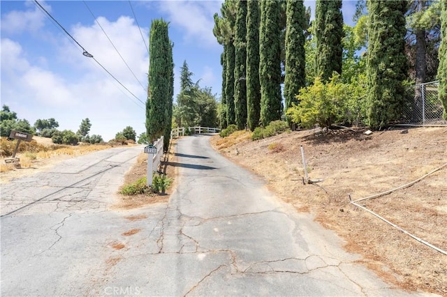 view of road with a gated entry